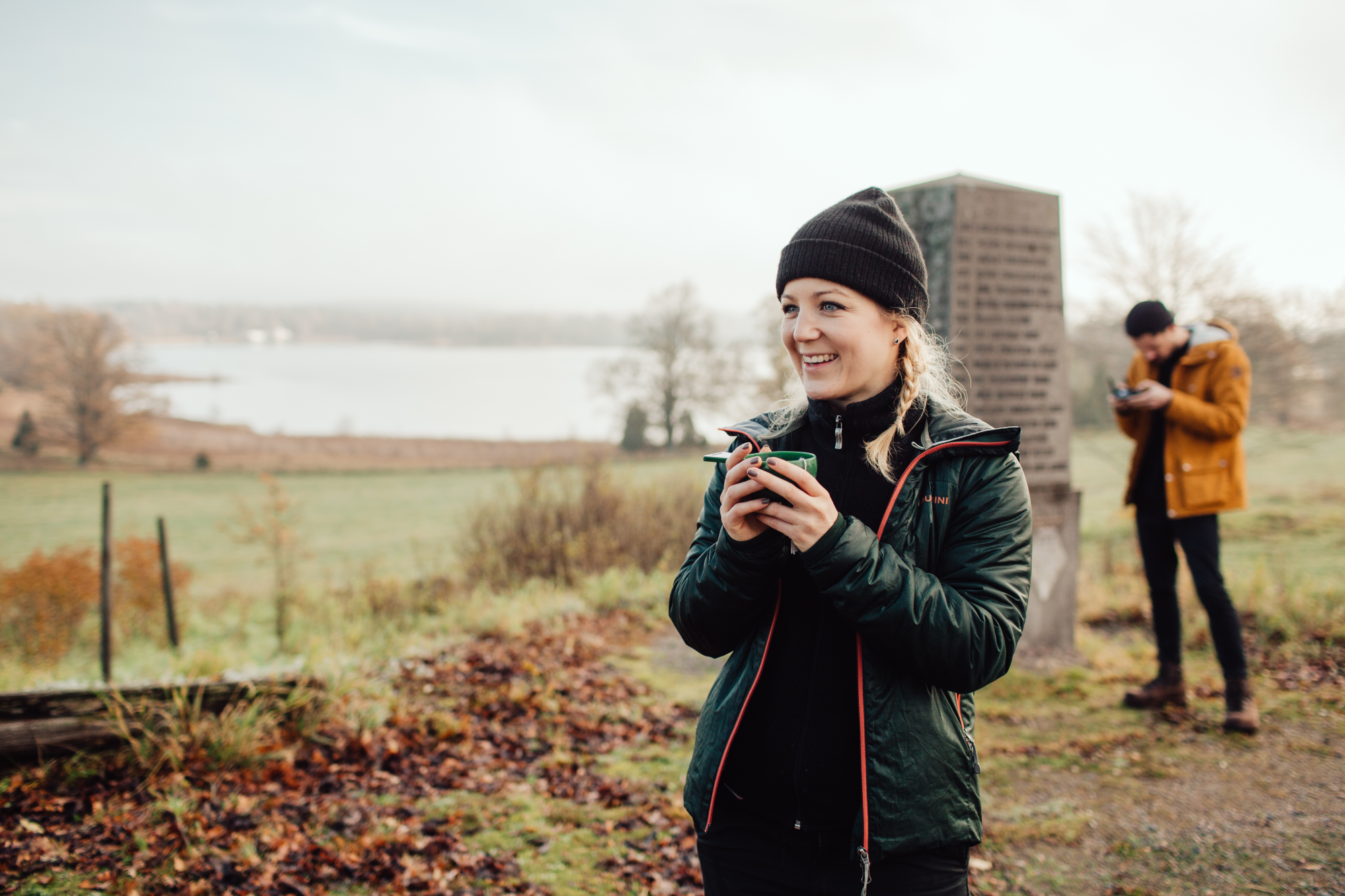 Kvinna som dricker kaffe ute i naturen